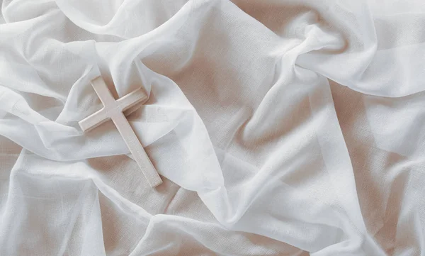 Good Friday and Holy week concept - A religious cross on white fabric background.