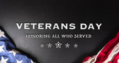 Happy Veterans day concept made from American flag and the text on dark wooden background.