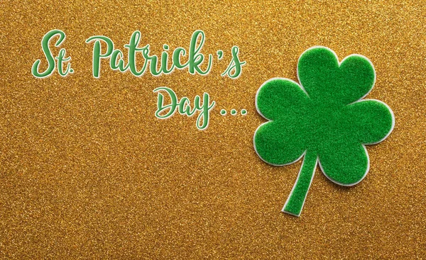 Happy St Patrick's Day decoration concept made from shamrocks ( clover leaf) on golden background.