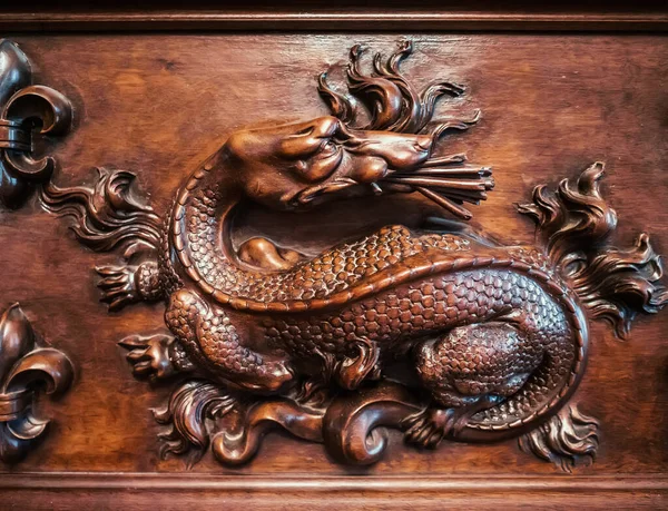 Carvings and decorations on ancient antique furniture in form of dragon.