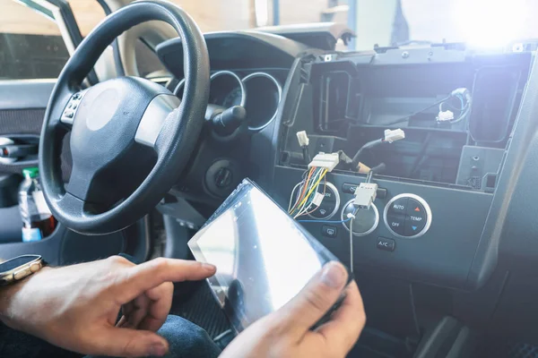 stock image Auto in Car Service, process of installing radio sound system. Auto electric hands on dashboard fixing problem close-up.