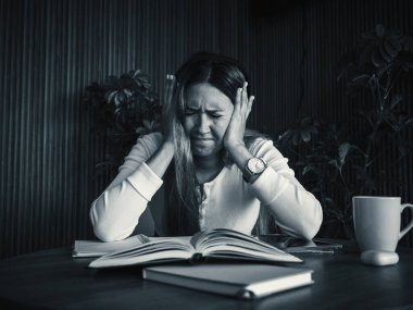 Stressed woman studying with books or tired from work, holding head in hands, expressing frustration. Academic pressure and mental strain. Education, stress, and emotional health. clipart