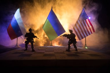 War between Russia and Ukraine, conceptual image of war using chess board, soldiers and national flags on the background of explosion. Ukrainian and Russian crisis. Selective focus