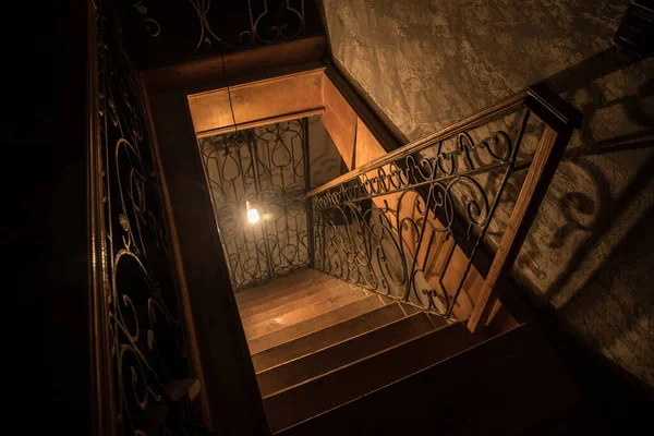 Creepy wooden stairs going down to the Basement in an abandoned house. Horror Halloween concept