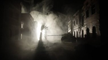 War Concept. Military silhouettes fighting scene on war fog sky background, World War Soldiers Silhouette Below Cloudy Skyline At night. Armored vehicles fight scene. Selective focus