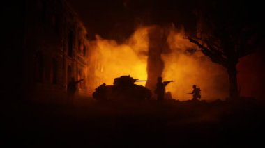 War Concept. Military silhouettes fighting scene on war fog sky background, World War Soldiers Silhouette Below Cloudy Skyline At night. Armored vehicles fight scene. Selective focus