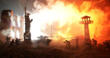 Conceptual image of war between Democracy and dictatorship using toy soldiers. Battle in ruined city. Selective focus 