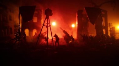Action (War) movie concept. Burned out city destroyed in war. Military fighting silhouettes. Selective focus 