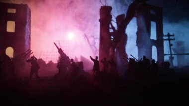 War Concept. Military silhouettes fighting scene on war fog sky background, World War Soldiers Silhouettes Below Cloudy Skyline At night. Battle in ruined city. Selective focus 