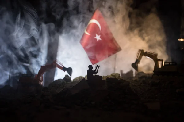 stock image Turkey Earthquake happend in February 2023. Decorative photo with Turkish flag, and ruined city buildings. Pray for Turkey. Selective focus