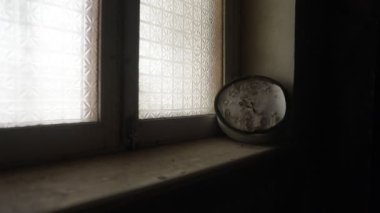 Old and vintage blank clock dial without hand on old wooden windowsill. Studio shot