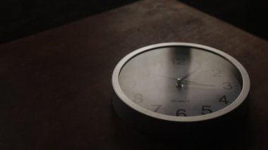 Time concept. Old rustic wall clock on old wooden table with copy space studio shot