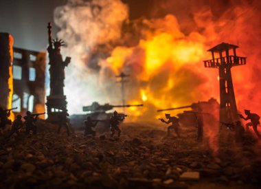Conceptual image of war between Democracy and dictatorship using toy soldiers. Battle in ruined city. Selective focus
