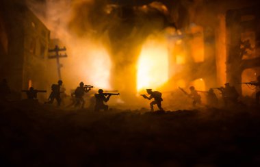 Conceptual image of war between Democracy and dictatorship using toy soldiers. Battle in ruined city. Selective focus