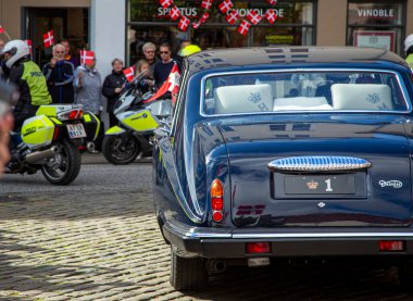 Queen Margrethe and Prince Henrik leaving the town hall at city Vejle in the  iconic Royal Daimler registration no.