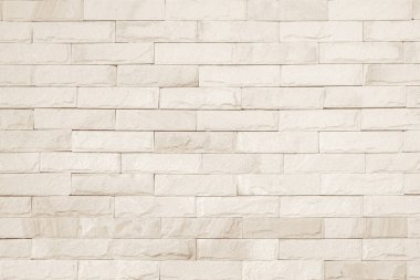 Geniş krem tuğla duvar dokusunun boş arkaplanı. Bej rengi eski tuğla duvar beton ya da taş desenli duvar kağıdı kireç taşı soyut döşeme. Düz olmayan iç kayalar. Ev dekorasyonu arkaplanı.