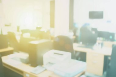 Blurred office working computer on desk busy at interior room workplace warm light, with corporate confidence images backdrop in work modern, Design abstract white blurry with defocused effect empty.