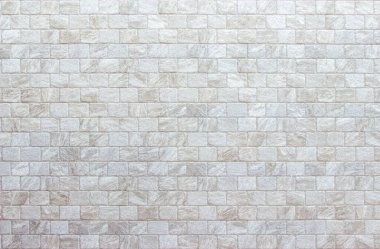 Geniş krem tuğla duvar dokusunun boş arkaplanı. Bej rengi eski tuğla duvar beton ya da taş desenli duvar kağıdı kireç taşı soyut döşeme. Düz olmayan iç kayalar. Ev dekorasyonu arkaplanı.