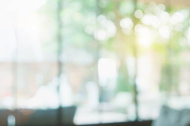 Arka plan için soyut bulanık kahve dükkanı ya da kafe. Bulanık restoran iç afişi. Kafe Bokeh 'le bulanıklaşıyor. Bulanık pencereler yeşil bahçe arka planı. Bulanık insanlar olmayan bir iş yeri. Masalar, iş yerindeki bina bulanıklığı.