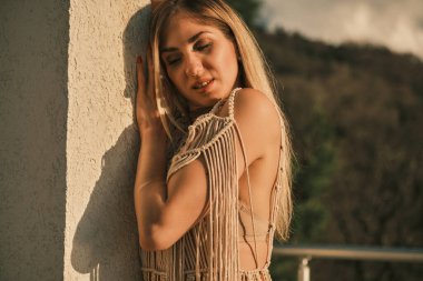 Yetişkin kız kendini beyaz duvara yasladı.