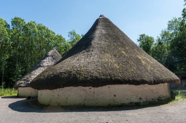 Cardiff, Wales / United Kingdom - June 13 2017: Iron Age Bryn Eryr Roundhouses reconstruction at St. Fagans Museum of History clipart