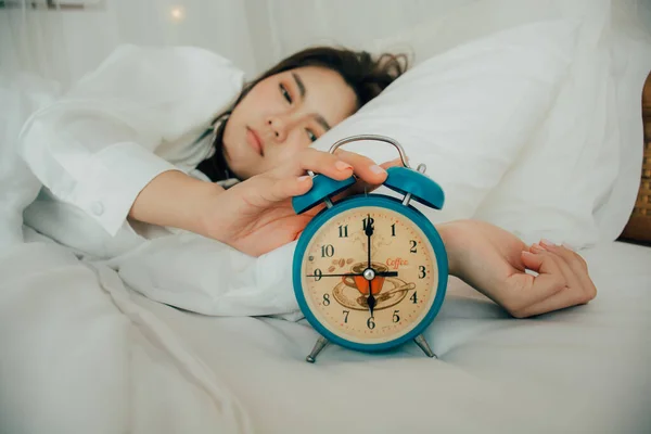 Asian Beautiful Woman White Pajamas Turning Alarm Clock While Sleepy — Stock Photo, Image
