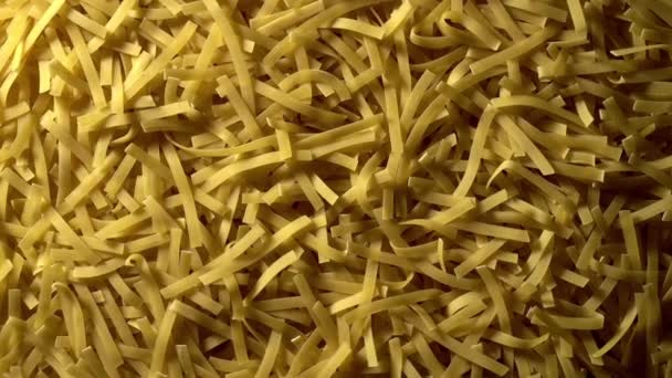 Uncooked Tagliatelle Lungo Pasta Rotating Slow Motion Top View Flat — Stok video