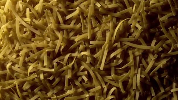 Uncooked Tagliatelle Lungo Pasta Rotating Slow Motion Top View Flat — Stockvideo