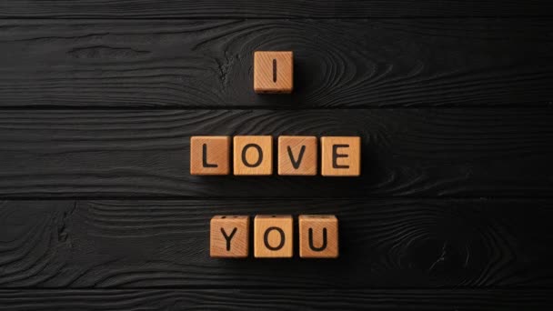 Stop Motion Wooden Cubes Phrase Love You Black Background Wooden — Stok video