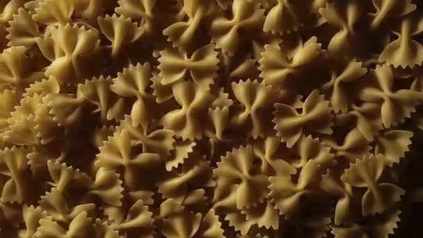 Uncooked Farfalle Pasta Rotating Slow Motion Top View Flat Lay — Stockvideo