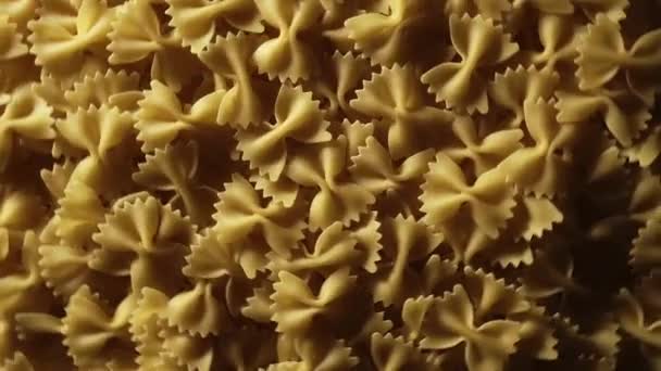 Uncooked Farfalle Pasta Rotating Fast Motion Top View Flat Lay — Stok video