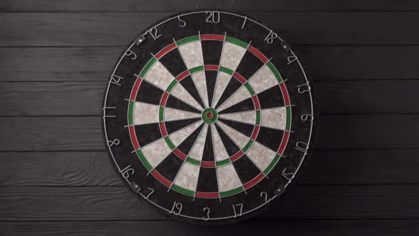 Three Darts Hit Dartboard Black Wooden Background Unlucky None Darts — Stock Video