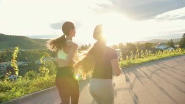 Sokakta koşan genç atlet kadınlar, çok antrenman yapıyorlar, yarış ya da maratona hazırlanıyorlar. Sağlıklı koşu ve açık hava egzersizi kavramı.