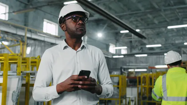 stock image Portrait of executive important African-American great mature middle-aged male worker holding keeping mobile phone. Man walking going on workplace attentively looking around.