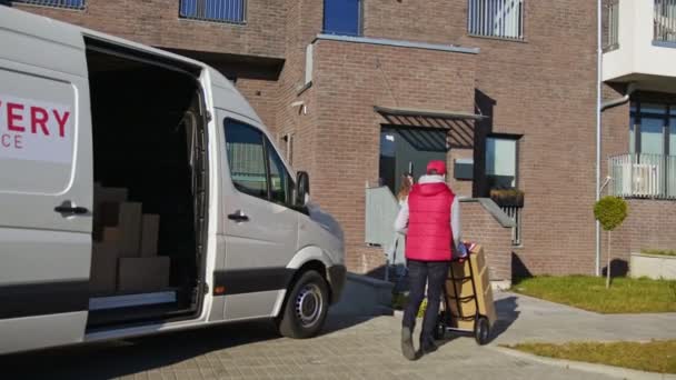 Caucasian Courier Red Uniform Carry Parcel Boxes Trolley Van Give — Stock Video