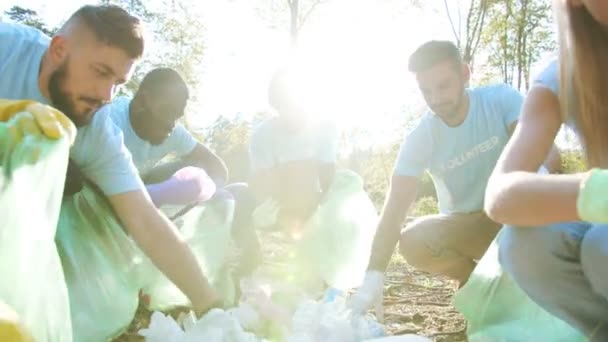 Diverse People Volunteers Same Shirts Taking Plastic Trash Putting Bin — Stock Video