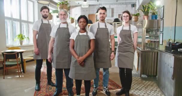 Camera Approaching Multi Ethnic Diverse Young Senior Waiters Aprons Stand — Wideo stockowe