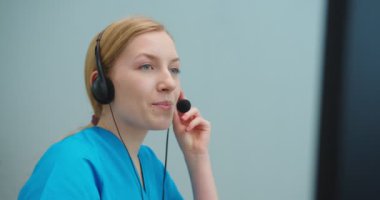 Kalabalık bir klinik çalışanının portresi bilgisayardaki hastayla görüntülü konferans yapıyor. Kafkas kadın hemşire tecrit sırasında tıbbi destek sağlıyor. İnternet, tıp konsepti.