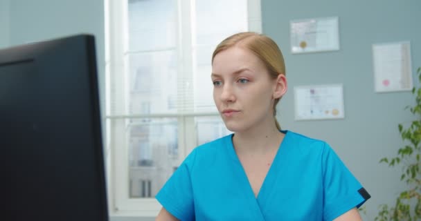 Female Nurse Blue Medical Uniform Documenting Entering Data Hospital Office — Stock Video