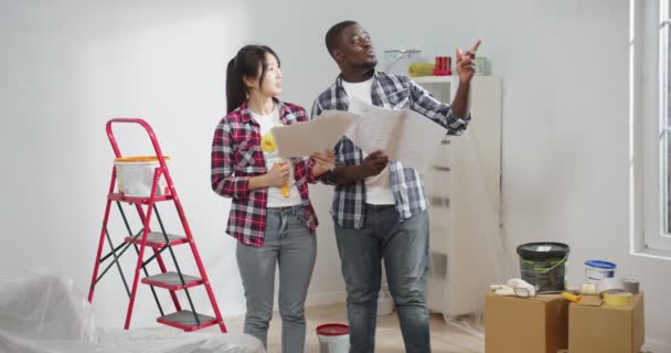 Mixed Races Young Man Woman Looking Blueprint Standing New Apartment — Stock Video