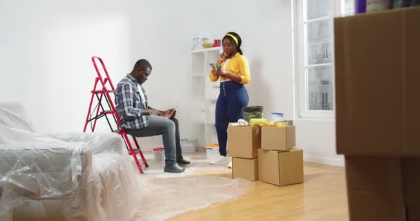 African American Young Family Couple Repairing Room Choosing New Wall — Stock Video
