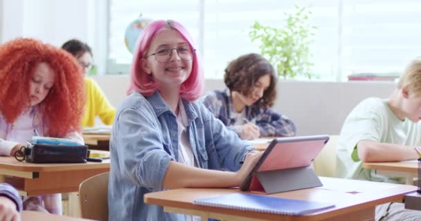 Portrait Happy Teenage Caucasian Girl Glasses Pink Hair Sitting Desk — Stock Video