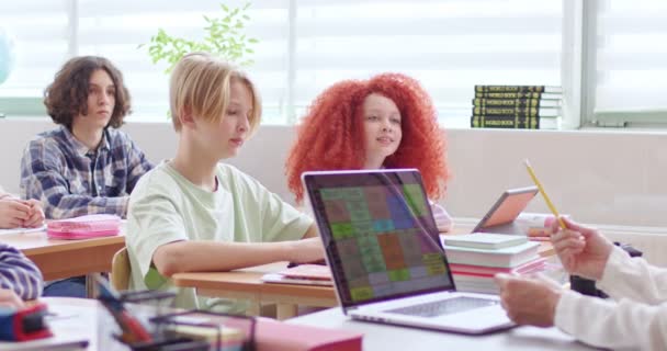 Caucasian Teens Kids Sitting Desks School Rising Hands Teacher Asking — Stock Video