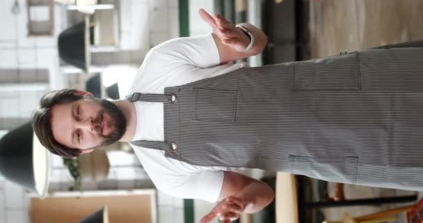 Young Bearded Man Apron Talks Camera Gesturing Hands Giving Instructions — Stock Video