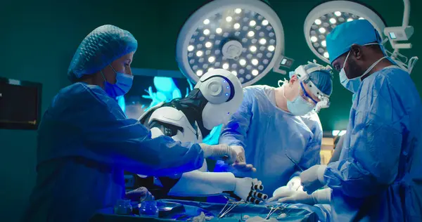 Robot performs operation on patient together with experienced specialists. Professional medical surgeons team work in operating room together with artificial intelligence.