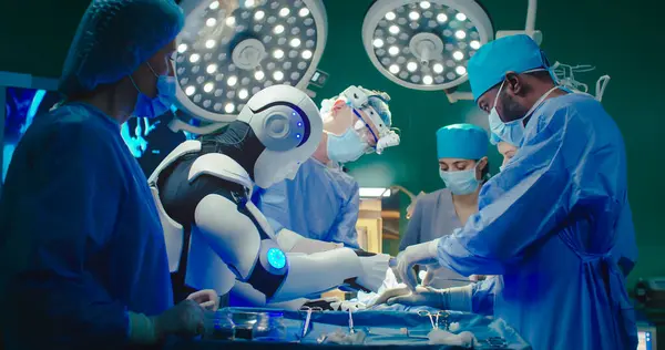 Robot and multiracial team of professional medical surgeons performs surgical operation in modern hospital. Doctors are working to save patient. Concept of future robotic surgery.