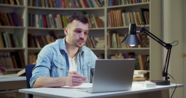 Young Male Taking Notes Notebook While Searching Information Online Notebook — Stock Video