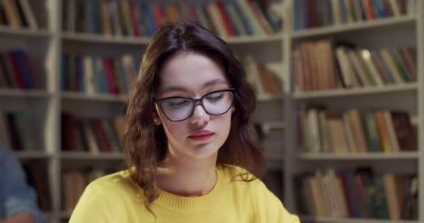 Lähikuva Nuori Valkoihoinen Kaunis Naispuolinen Opiskelija Lasit Työskentelevät Kirjastossa Tauolla — kuvapankkivideo