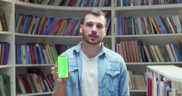 Portrait Young Caucasian Handsome Male Student Smiling Showing Smartphone Green — Stock Video