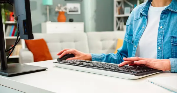 stock image Close up portrait of womans hands on keyboard. Female sits at table with computer types on keyboard at home. Work online at home.